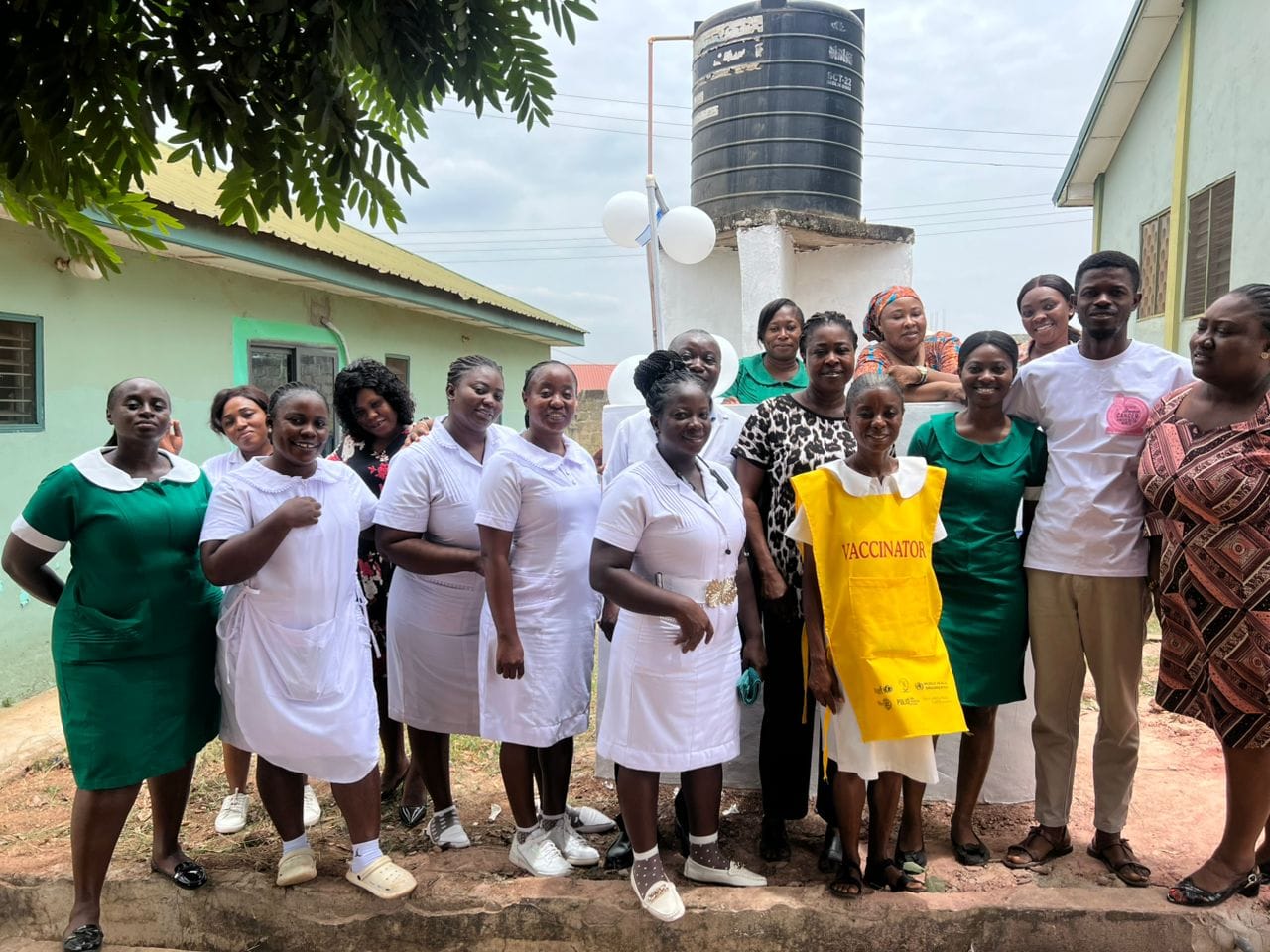 Staff gathered at the Apatrapa Clinic water tank