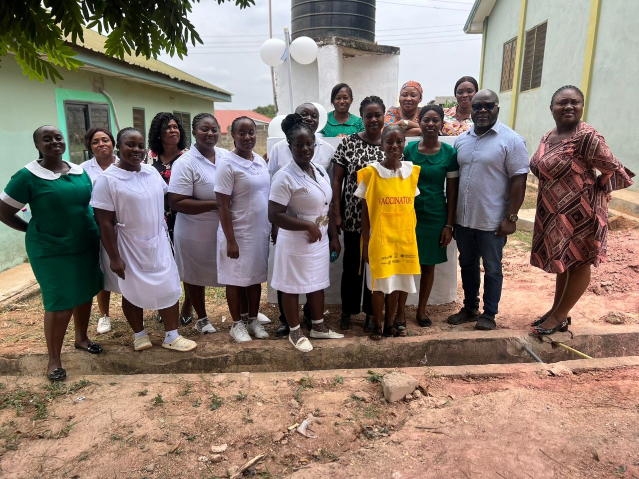 Clinic staff gathered at the Apatrapa Clinic water tank