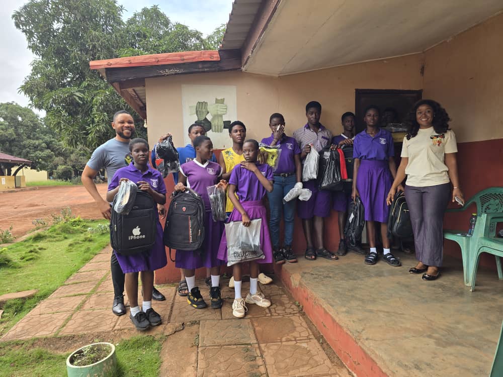 Schoolchildren at Foster Home Orphanage holding donated bags
